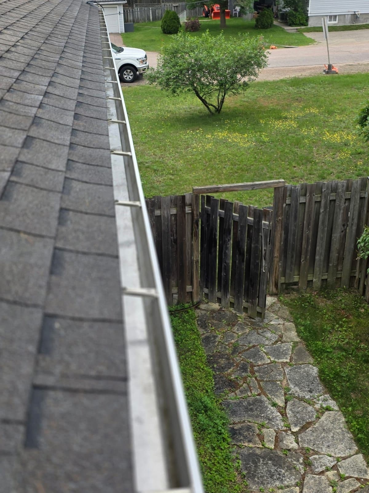 Spotless gutter and downspout flowing freely after a Prestige View Services gutter cleaning in the Ottawa Valley