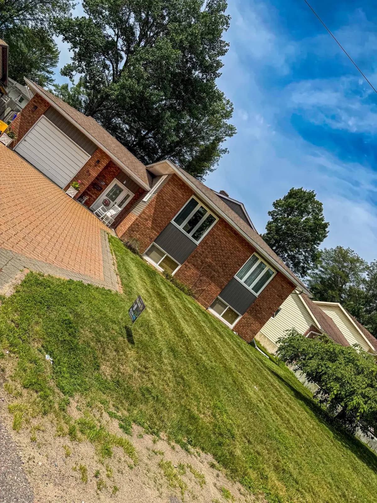 Sharp fresh-cut front lawn at a brick home in Pembroke after a PVS visit