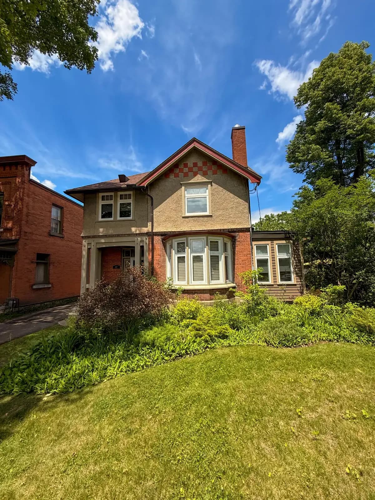 Heritage brick home in Pembroke with clean bay windows after professional window cleaning