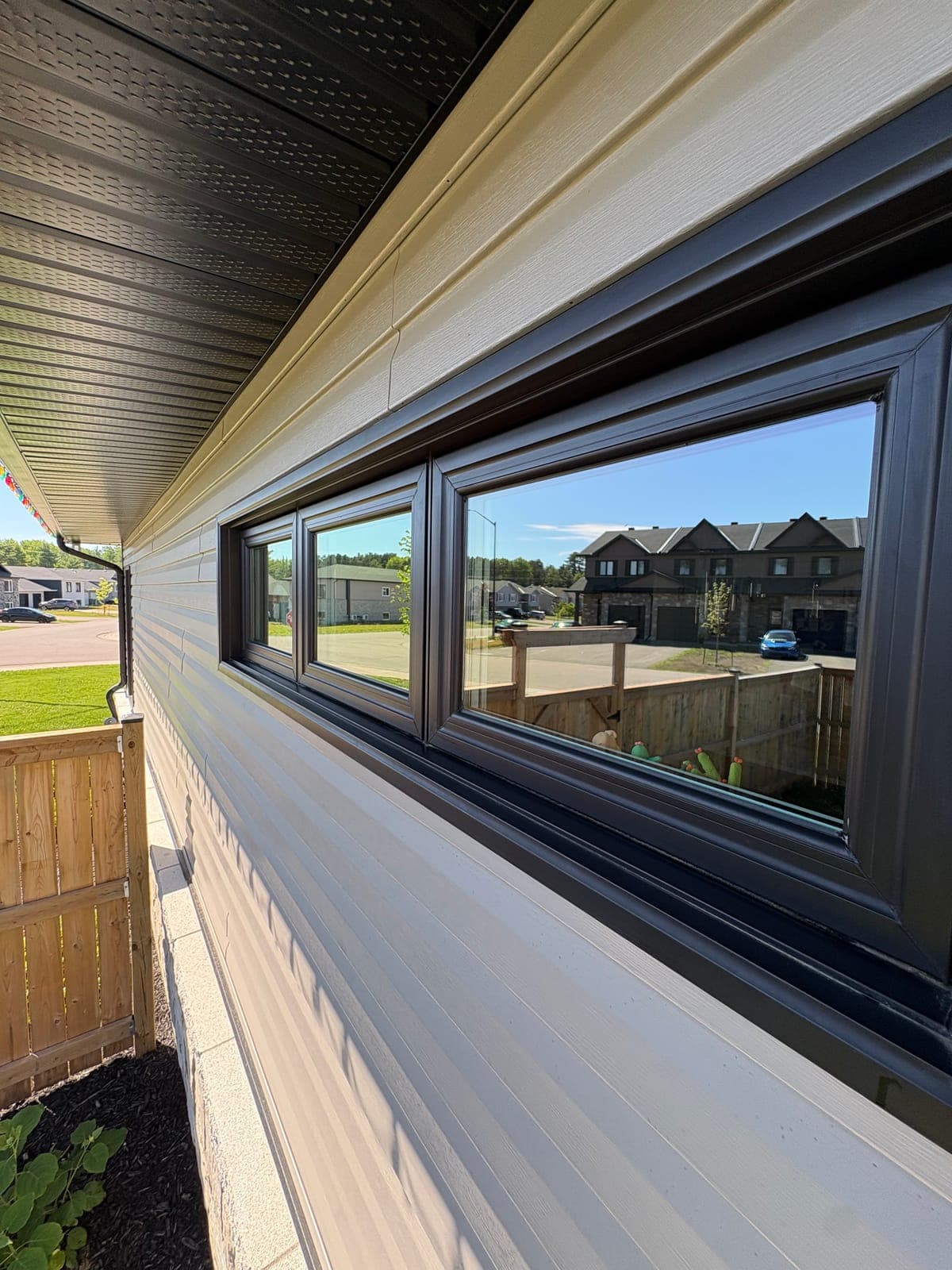 Crisp dark-framed residential windows after a PVS window cleaning visit